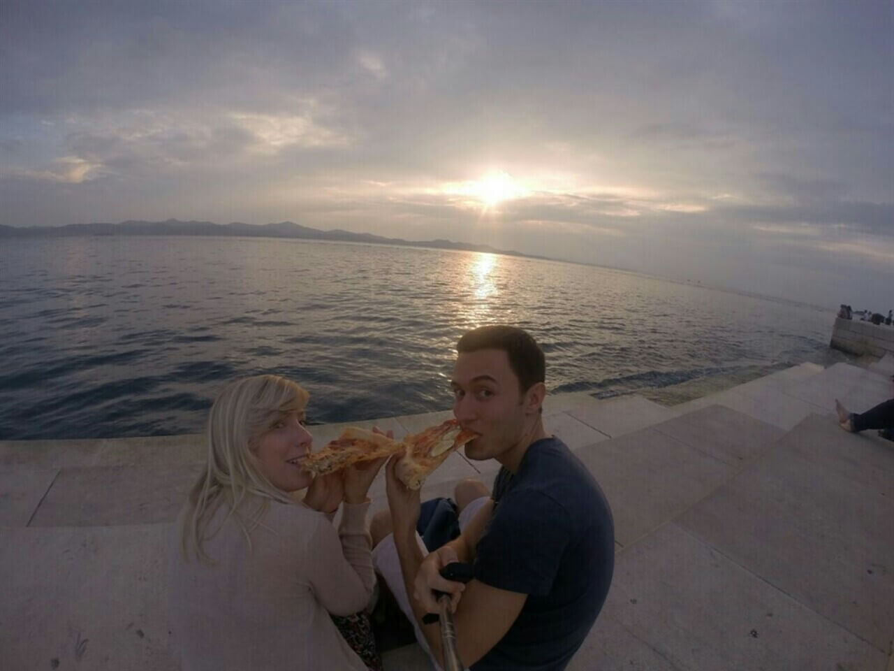 Eating pizza on the sea organ in Zadar, Croatia